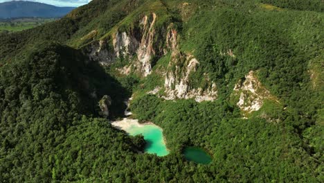 Rainbow-mountain-cliffs-with-crater-lakes-in-lush-green-forest-of-New-Zealand