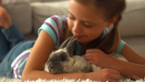 happy girl with pet rabbit