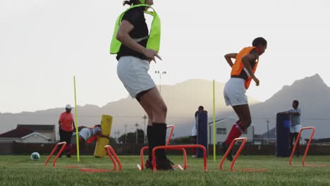 Young-adult-female-rugby-team-training