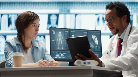 african american medic presenting the diagnostic reports to a female patient