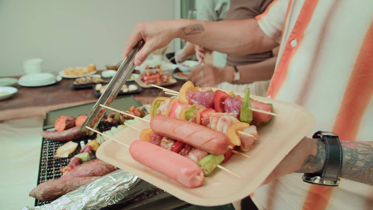 Hands of Person Grilling Food during Party with Friends