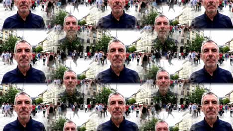 a man stands still in a bustling city plaza as people walk by in various directions. the surrounding architecture creates a vibrant atmosphere filled with movement and energy.