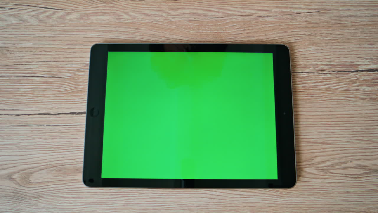 Green screen horizontal tablet placed at remote workplace closeup top view