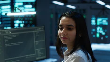 Portrait-of-cheerful-engineer-in-data-center-installing-software-on-computer