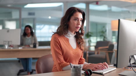 businesswoman working at her computer in an office