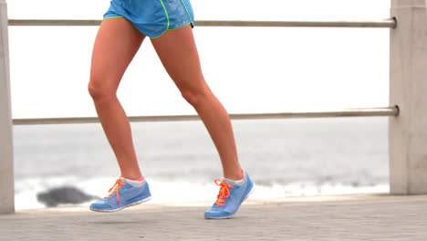 female legs running by the sea