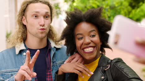 Two-edgy-people-taking-a-selfie-using-their-phone