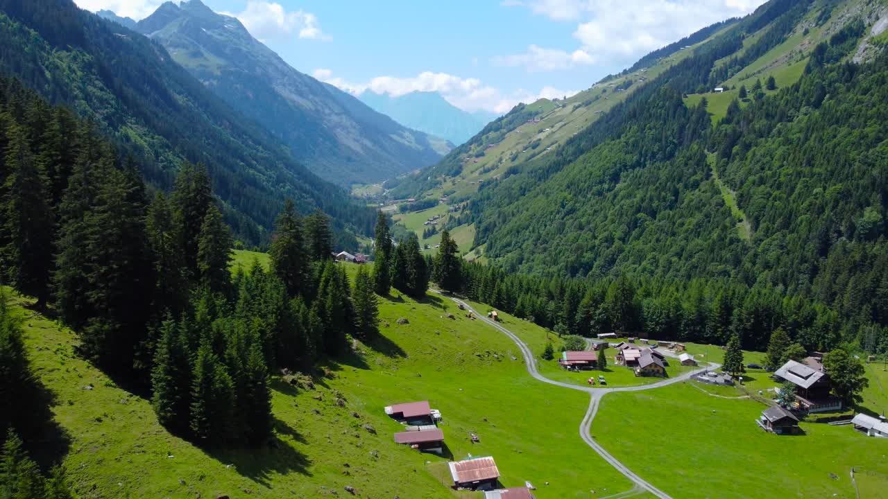 Aerial dolly above calm Untersch&auml;chen village on clear blue sky day