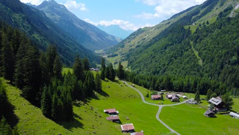 aerial dolly above calm unterschächen village on clear blue sky day