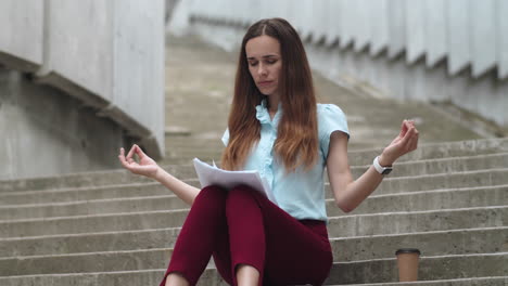 businesswoman meditating on street. business woman drinking take away coffee