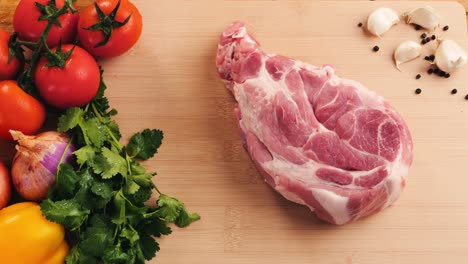 preparing raw pork chop with vegetables