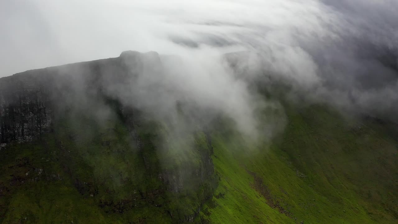 lapso de tiempo de las nubes rodando sobre las colinas en las islas feroe, vista aérea
