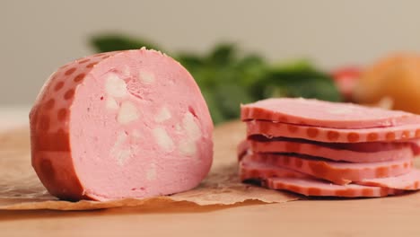 ham italian mordatella, man slices of traditional italian antipasti mortadella sausage on a wooden cutting board, close up macro of chicken or turkey jamon, fat breakfast dish.