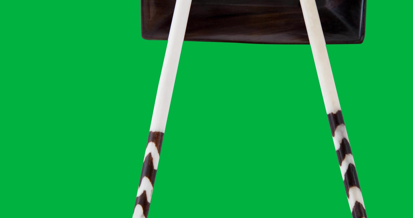 Sushi text banner with chopsticks on a plate against black background