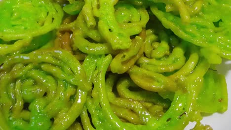 crispy sweet asian dessert green jalebi cooked and served in festivals.