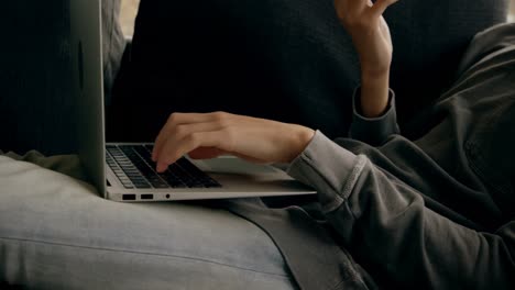 Man talking on mobile phone while using laptop at home 4k