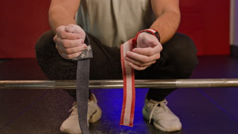 sportswoman preparing to lift barbell