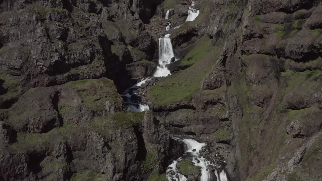 Aerial View of a Waterfall cascading down a Mountainside in Iceland