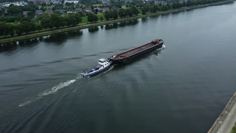 canal barge being towed by tugboat