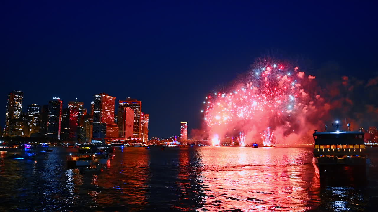 Magnificent fireworks splashes over the waterscape. Night view of New York from the river