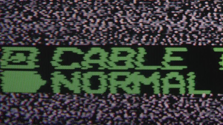 Green Pixelated 'CABLE NORMAL' Text on TV Static Screen
