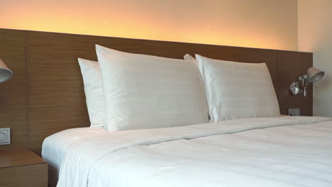 Close-Up-of-Kingsize-Bed-in-Master-Bedrrom-Suite,-White-Sheets-and-Pillows,-Pan