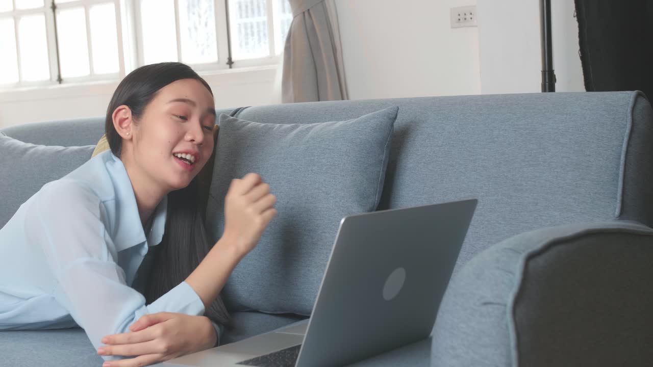 Woman Lying On A Sofa And Video Call With Friend In Home Living Room, Video In 4K