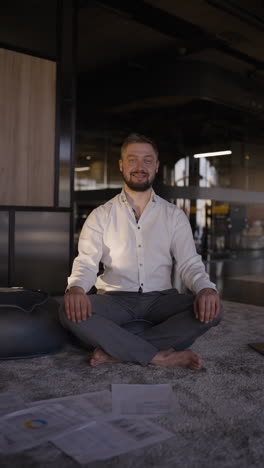 businessman meditating in modern office