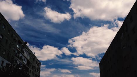 various timelapses of cloud movement in between communist building in romania