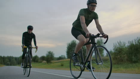 Zwei-Fitte-Radfahrer-Treten-Auf-Der-Straße-Gegeneinander-An