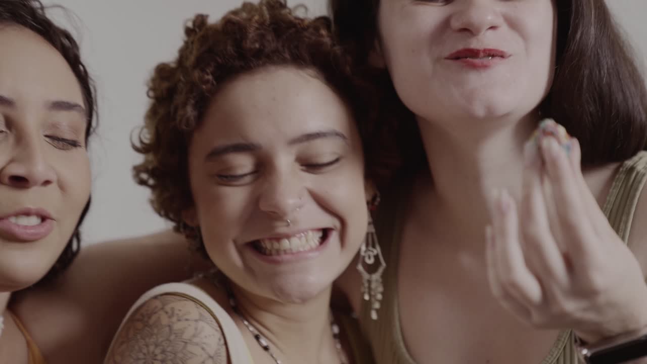 Joyful Group of Women Laughing and Sharing a Snack