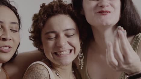 joyful group of women laughing and sharing a snack