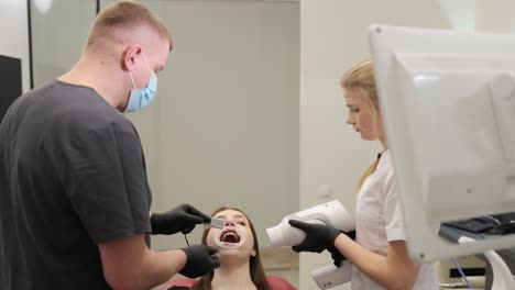 a dental team offers comprehensive care and effective treatment to a patient using advanced equipment and technology. vertical video