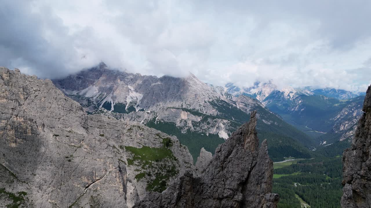 Dolomites, Italy - A Breathtaking View of the Towers of Mordor, Nearly Touching the Clouds - Drone Flying Forward
