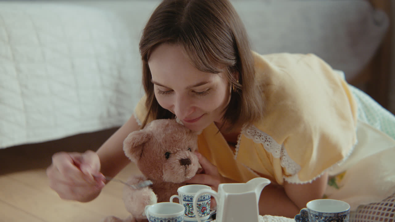 A girl playing with dolls in her room