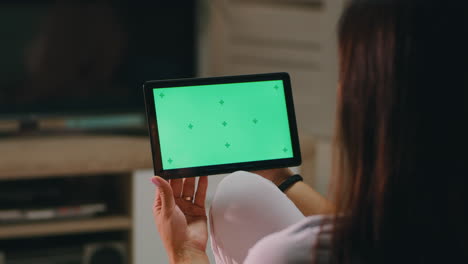 woman with tablet and baby in the living room