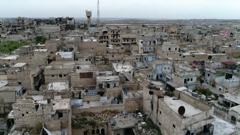 drone flying over a syrian city. some of the buildings are still in ruins after the civil war 10 years ago - aerial view 4k