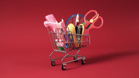 cerca del carrito de compras con artículos escolares y espacio de copia en fondo rojo