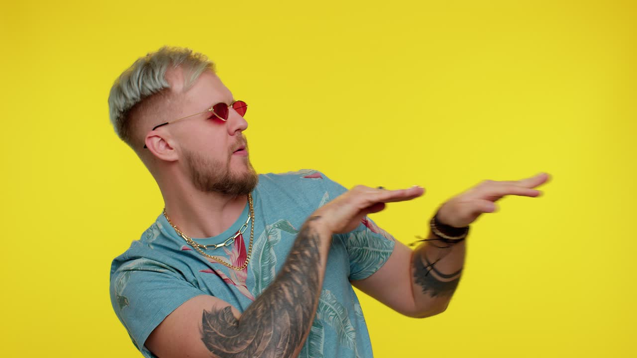 Cheerful tourist man listening music dancing disco fooling around having fun, gesticulating hands