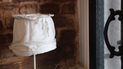 antique white fabric garment on display