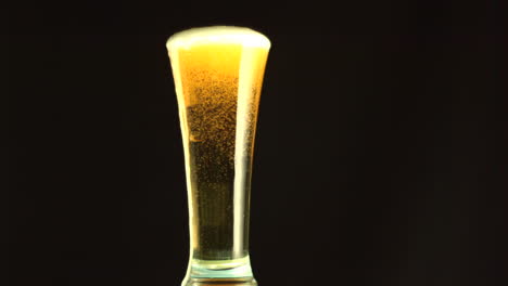 beer overfilling a glass