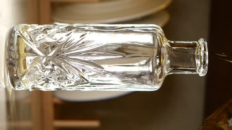 pouring oil into a decorative glass bottle