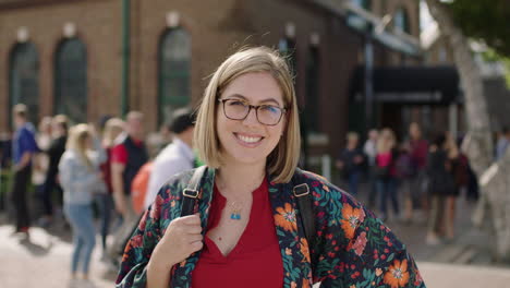 portrait of trendy young blonde woman smiling confident optimistic wearing glasses floral shirt in urban background