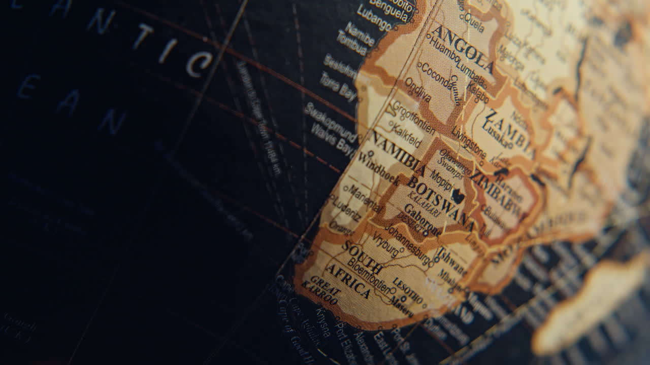 Macro view vintage globe with marked geographical elements. Names seas oceans