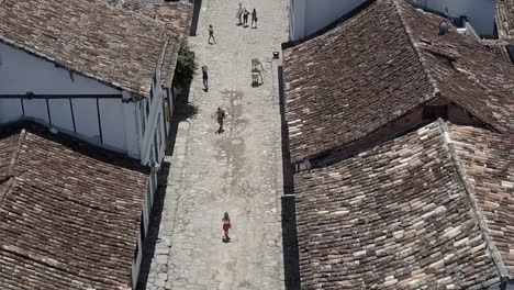 Woman-walking-through-the-streets-of-Paraty,-Brazil