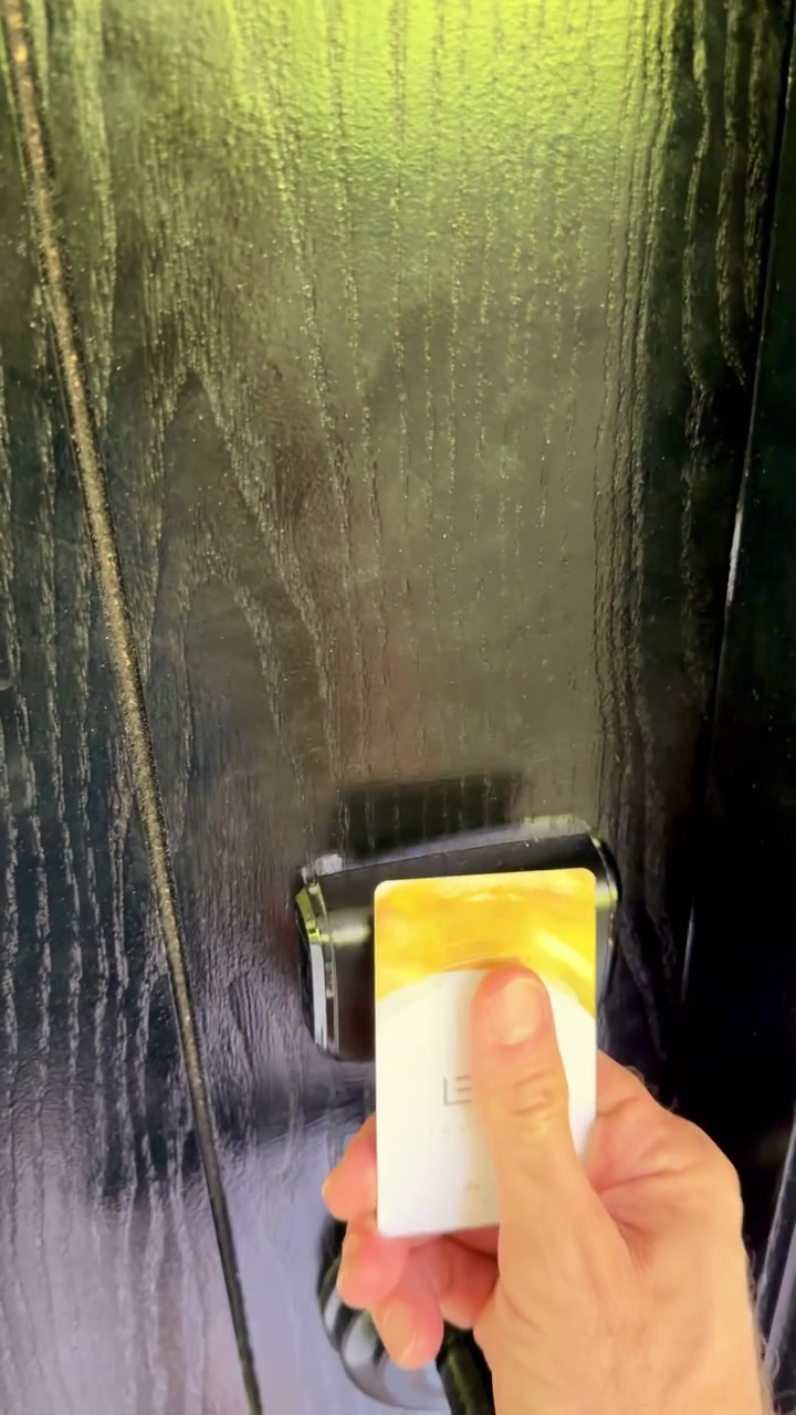 Hotel guest unlocking the door with an electronic key card. Vertical influencer-style POV footage of a male traveler walking toward a hotel room and opening his room. vacation influencer vibe