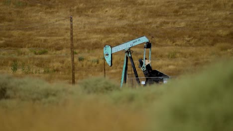 4k footage of a painted working oil rig at a distance