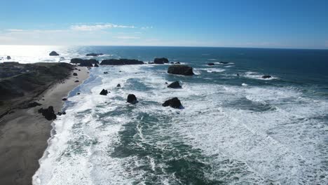 beautiful 4k aerial drone shot with blue skies rising above bandon beach in oregon on a sunny day