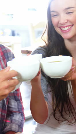 group of friends toasting cup of coffee