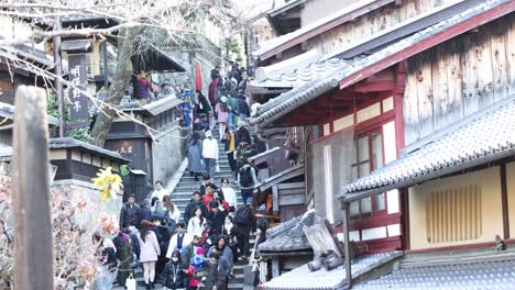 people ascending and descending busy outdoor stairs